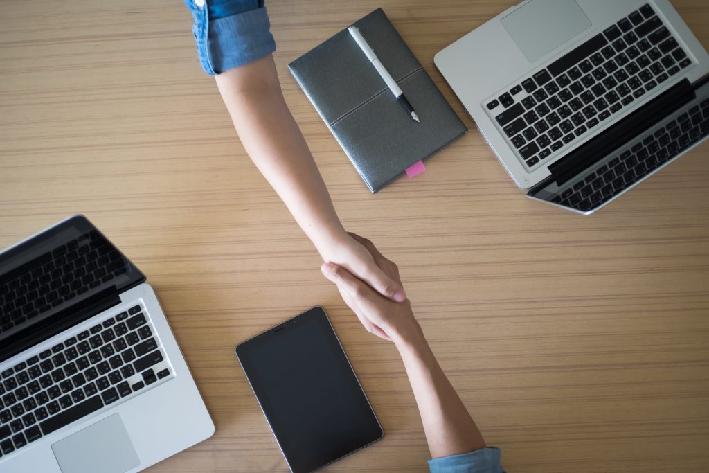 two businesspeople shaking hands indoors
